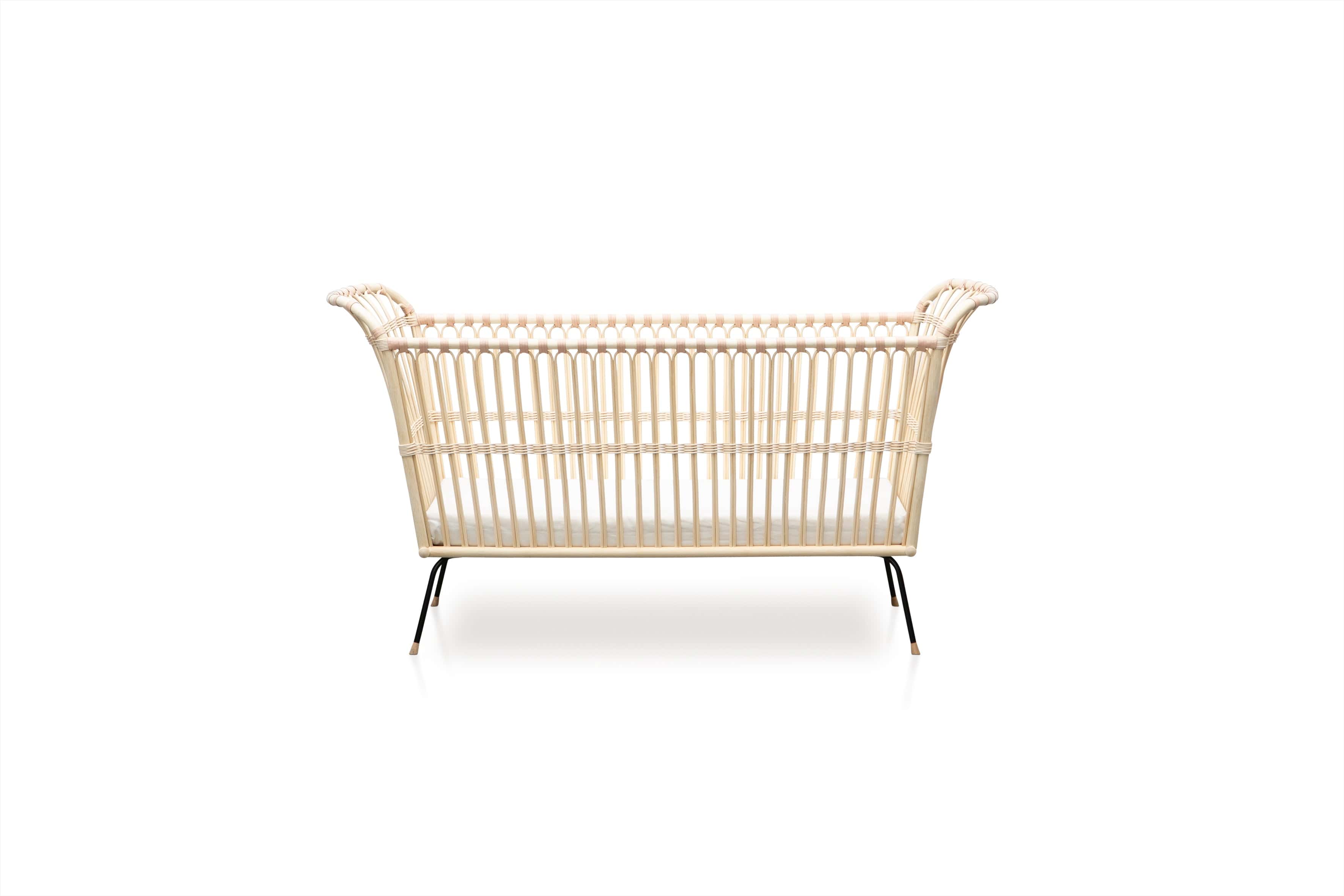 Square bed with high sides. The shorter sides of the bed are slightly higher and rounded. Made of beige rattan beams, connected with beige leather straps and standing on short slim black metal legs.