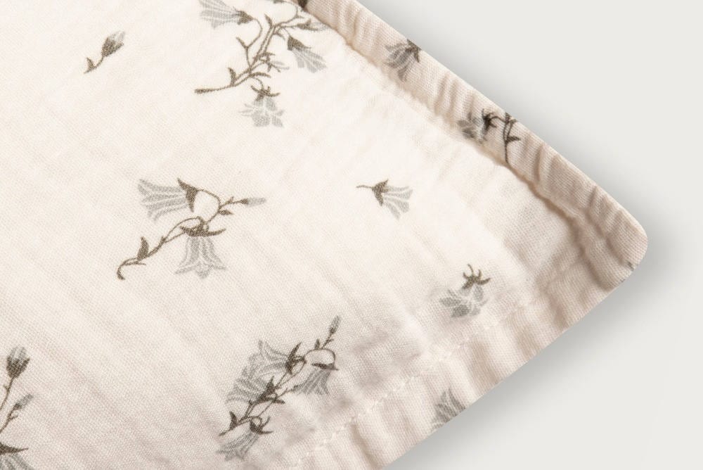 Close up of cotton bedding in color pink with bell flowers print