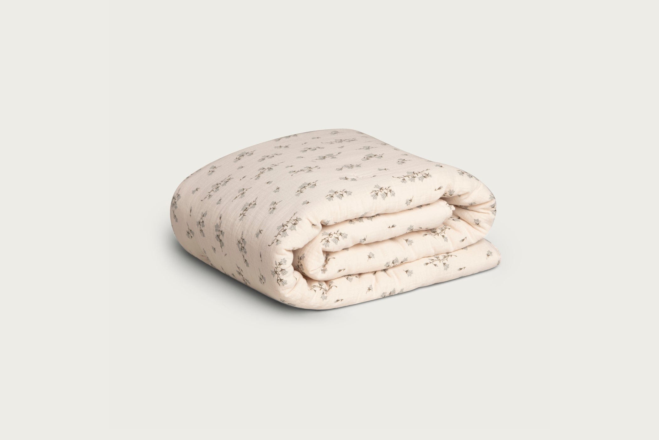 Soft cream colored filled cotton muslin blanket, with bellflower print