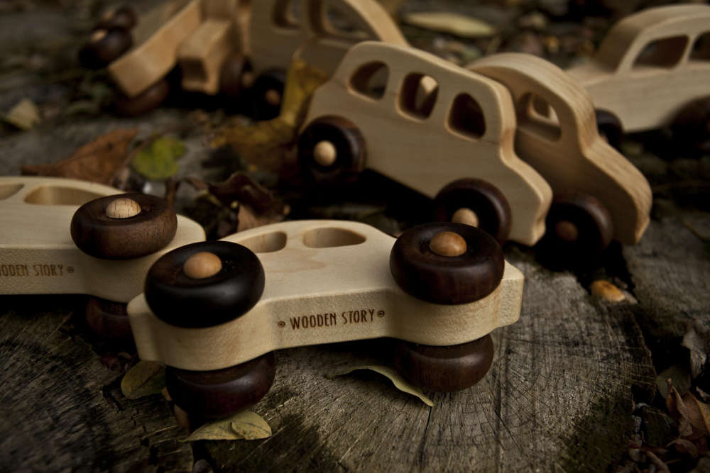 Wooden toy cars lying outside on the floor